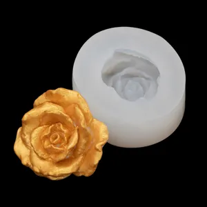 Close up view of 3D rose flower silicone mold and golden resin casting finished piece.
