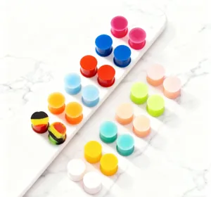 Colorful silicone ear plugs and tunnels set for body piercing, soft stretchers jewelry pairs.