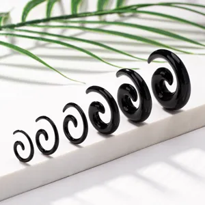 Black acrylic spiral ear tappers and stretchers set, detailed view of body piercing jewelry.