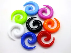 Detailed close up view of vibrant acrylic spiral ear stretchers and piercing jewelry parts.