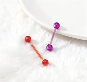 Detail shot of colorful plastic tongue ring piercing jewelry and replacement uv barbells.