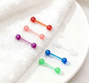 Detailed view of colorful pearl UV tongue rings, soft barbell body piercing jewelry pieces.
