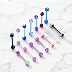 Detailed shot of colorful acrylic tongue rings with UV soft stems, sweet candy patterns for body piercing.