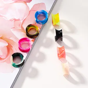 Colorful silicone ear plugs and tunnels body piercing jewelry set with detailed view.