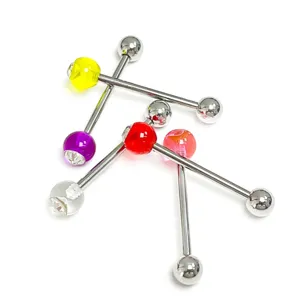 Detailed shot of body piercing jewelry, colorful acrylic and diamond balls on steel barbells.