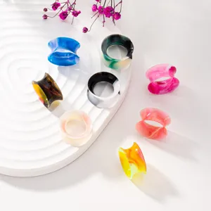 Detailed shot of colorful silicone ear gauges, flexible hollow ear tunnels, body piercing jewelry.