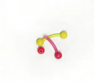 Curved barbell body piercing jewelry detail closeup, colorful replacement balls for eyebrow stud.