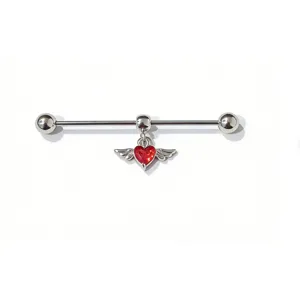 Industrial barbell piercing detail featuring a striking winged red crystal heart pendant.