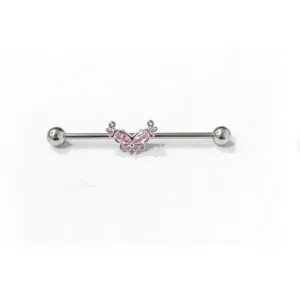 Close-up detail of silver industrial barbell body piercing with pink crystal butterfly.