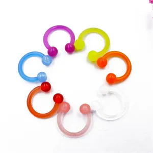 Detailed close-up of colorful acrylic horseshoe rings, body piercing jewelry set for daily use.