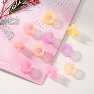 Colorful silicone ear tunnels detail view, soft and flexible flesh gauges for body piercing.
