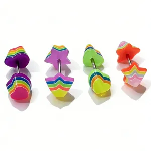 Close-up of colorful acrylic star and heart piercing jewelry with rainbow stripe details.