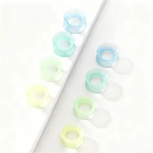 Silicone ear tunnels and plugs in soft pastel gradient colors, comfortable body jewelry.