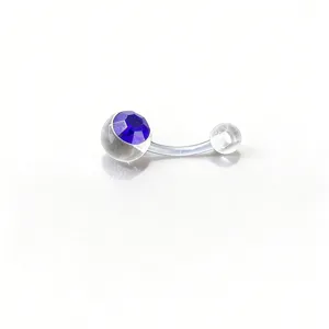 Close-up detail of clear body piercing belly ring featuring a faceted blue gemstone bead.