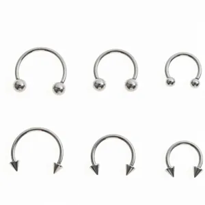 Set of stainless steel horseshoe barbell body piercing rings with balls and spikes for daily use.