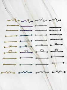 Detailed view of industrial barbell cartilage piercing jewelry in various colors and shapes.