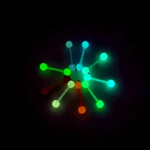 Glow in the dark tongue ring detail showing bright luminous colorful balls on UV barbell.