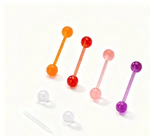 Close-up detail of colorful UV acrylic body piercing barbells and replacement balls.