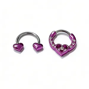 Detailed close-up of purple heart piercing jewelry, horseshoe and clicker ring design.