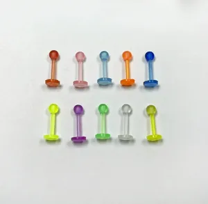 Close-up detail of colorful acrylic lip studs body piercing jewelry set in various vivid shades.