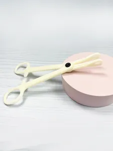 Close-up of acrylic body piercing auxiliary tool, beige closing plier detail for professional use.