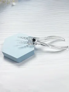 Transparent acrylic body piercing tool, detail view of the clear closing plier for professional use.