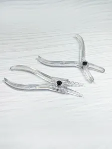 Clear acrylic body piercing pliers tool, transparent closing clamp detail view for safe use.