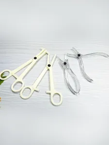 Detailed view of transparent acrylic and white plastic body piercing clamps and tools.