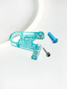 Disposable body piercing tool detail, transparent blue clamp and metal stud component.