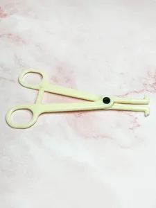 Plastic body piercing closing tool detail shot, useful for body jewelry and ear piercing.