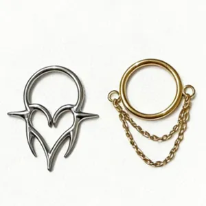 Detailed view of silver heart thorn and gold chain piercing rings, perfect for body jewelry.