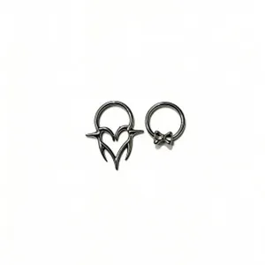 Detail view of gothic devil heart and cute bow piercing rings, punk style body jewelry.