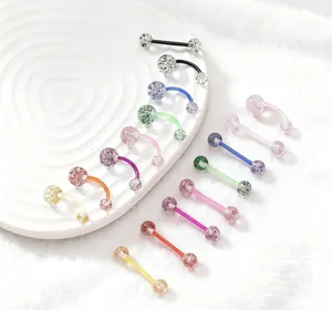 Close-up view of colorful glitter acrylic body piercing jewelry, curved and straight barbells.