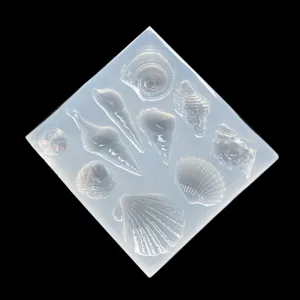 Clear silicone resin mold featuring seashell and conch shapes for DIY pendant crafting.
