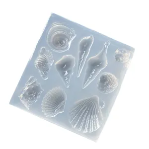 Clear silicone resin mold with ocean seashell and conch shapes for DIY pendant casting.