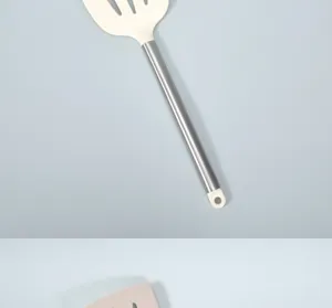 Silicone slotted spatula detail view with stainless steel handle for modern kitchen cooking.