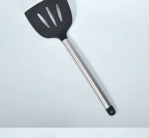 Durable silicone slotted spatula with stainless steel handle, heat resistant cooking tool detail.