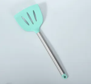 Silicone slotted spatula with stainless steel handle, heat resistant kitchen cooking tool detail.