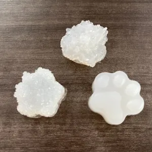 Detail view of DIY crystal epoxy resin cat paw molds and glitter filler accessories.