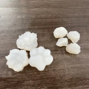 Close-up of DIY silicone resin cat paw molds and glitter crystal epoxy craft accessories.