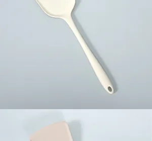 Detail view of thick one-piece silicone cooking spatula, heat-resistant kitchenware tool.