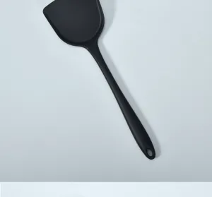 Detailed view of a black silicone spatula, non-stick cookware kitchen cooking tool.