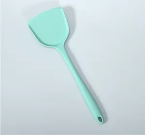 Mint green silicone spatula detail, seamless one-piece kitchen utensil for non-stick cookware.