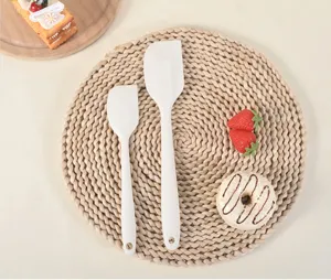 Silicone spatula set baking tools detail view, white kitchen utensils for cake cream spreading.