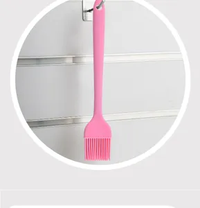Pink silicone basting brush for kitchen, baking and barbecue with convenient hanging hole.