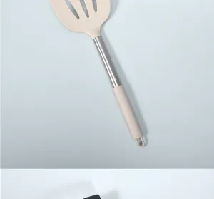 Stainless steel handle and heat resistant silicone slotted spatula detail view close up cook.