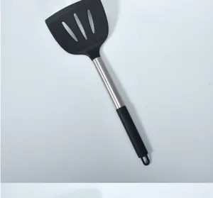 Silicone slotted spatula detail shot showcasing heat-resistant black head and steel handle.