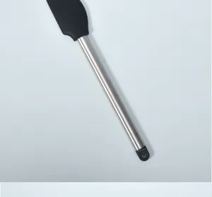 Detailed close-up view of the stainless steel handle and silicone head of a kitchen baking spatula.