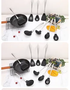 Stainless steel silicone kitchen utensil set detail showing spatula and spoon on white marble.