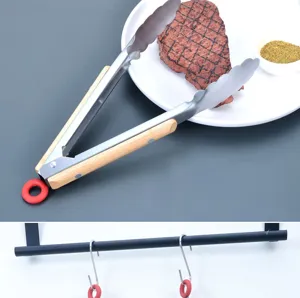 Stainless steel food tong with wooden handle and hanging ring detail, perfect for BBQ and steak.